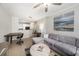 Open-concept living room view with sofa, kitchen, and office area with desk and chair at 4221 W Spruce St # 2104, Tampa, FL 33607