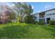 Inviting backyard with mature trees offering a serene escape and lush lawn for outdoor activities at 4325 58Th N Way # 1527, Kenneth City, FL 33709