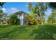 Exterior view of a condominium building with a well-manicured lawn and lush tropical landscaping at 4325 58Th N Way # 1527, Kenneth City, FL 33709