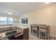 Modern kitchen showcasing granite counters, stainless oven, and a breakfast bar for casual dining and entertaining at 4325 58Th N Way # 1527, Kenneth City, FL 33709