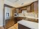 Updated kitchen features stainless appliances, tiled backsplash, and granite counters for cooking and entertaining at 4325 58Th N Way # 1527, Kenneth City, FL 33709