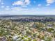 Sweeping aerial panorama of a suburban area with homes, water features, and a city skyline in the distance at 4400 Helena Ne St, St Petersburg, FL 33703