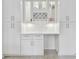 Stylish bar area with white cabinets, glass shelves, wine rack, and built-in lighting at 4400 Helena Ne St, St Petersburg, FL 33703
