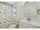 Updated bathroom featuring white vanity, modern mirror and fun dinosaur shower curtain at 4400 Helena Ne St, St Petersburg, FL 33703