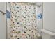 Close-up of updated bathroom showing fun dinosaur themed shower curtain at 4400 Helena Ne St, St Petersburg, FL 33703
