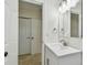 Bathroom featuring a sleek vanity, mirror, and closet with folding doors at 4400 Helena Ne St, St Petersburg, FL 33703
