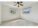 Well-lit bedroom with ceiling fan, two windows offering bright views at 4400 Helena Ne St, St Petersburg, FL 33703