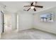 Bedroom with ceiling fan, window and doorway to hallway at 4400 Helena Ne St, St Petersburg, FL 33703