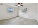 Bright bedroom featuring two windows and white walls and ceiling fan at 4400 Helena Ne St, St Petersburg, FL 33703
