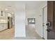 Inviting foyer with light-colored walls and terrazzo flooring leads to a spacious living area and a modern kitchen at 4400 Helena Ne St, St Petersburg, FL 33703
