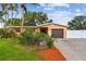 Well-maintained single-story home with a brick driveway, mature landscaping, and privacy fence at 4400 Helena Ne St, St Petersburg, FL 33703