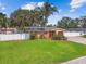 Inviting home with a well-manicured lawn, brick driveway, and a fenced front yard at 4400 Helena Ne St, St Petersburg, FL 33703