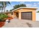 Well-maintained single-story home featuring a brick driveway, landscaping, and an attached garage at 4400 Helena Ne St, St Petersburg, FL 33703