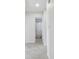 Hallway leading to updated bathroom featuring modern fixtures and a fun shower curtain at 4400 Helena Ne St, St Petersburg, FL 33703