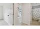 Hallway between rooms showing access to bedroom and updated bathroom at 4400 Helena Ne St, St Petersburg, FL 33703