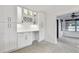 Bright kitchen boasts new white cabinets, wine rack, modern backsplash, and ample counter space at 4400 Helena Ne St, St Petersburg, FL 33703