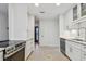 Spacious kitchen with white cabinets, stainless steel appliances, and terrazzo flooring at 4400 Helena Ne St, St Petersburg, FL 33703