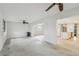 Bright, open-concept living room with modern ceiling fans and adjacent updated kitchen at 4400 Helena Ne St, St Petersburg, FL 33703