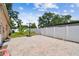 A brick patio with a basketball hoop and white fence in the backyard at 4400 Helena Ne St, St Petersburg, FL 33703