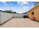 Brick paved patio with a white fence and a pink chair near a tan-colored house at 4400 Helena Ne St, St Petersburg, FL 33703