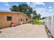 The exterior patio has a brick foundation with a white fence all around at 4400 Helena Ne St, St Petersburg, FL 33703