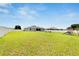 Expansive backyard featuring lush green lawn, fencing, and outdoor seating area at 4435 Devinshire Fields Loop, Plant City, FL 33567
