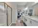 Bathroom featuring double sinks, a walk-in shower, and contemporary finishes at 4435 Devinshire Fields Loop, Plant City, FL 33567