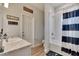 Clean bathroom with a tub-shower combo, vanity, and humorous wall art at 4435 Devinshire Fields Loop, Plant City, FL 33567