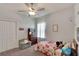 Cozy bedroom featuring playful decor, a patterned bedspread, and a comfortable chair at 4435 Devinshire Fields Loop, Plant City, FL 33567