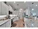 Bright kitchen boasts granite countertops, white cabinets, and stainless steel appliances at 4435 Devinshire Fields Loop, Plant City, FL 33567