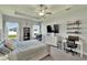 Relaxing main bedroom featuring a tray ceiling, a sitting area, and plenty of natural light at 4435 Devinshire Fields Loop, Plant City, FL 33567