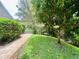Charming backyard featuring a brick walkway, lush lawn, and mature landscaping at 4808 Jewell Ter, Palm Harbor, FL 34685