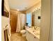Bathroom with vanity, mirror, shower with curtain and adjacent plant for fresh decor at 4808 Jewell Ter, Palm Harbor, FL 34685