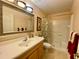 Traditional bathroom featuring a vanity with ample counter space and a shower with curtain at 4808 Jewell Ter, Palm Harbor, FL 34685