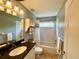 Bathroom with shower-tub combination, granite vanity, and decorative accents at 4808 Jewell Ter, Palm Harbor, FL 34685