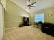 Bright room with ceiling fan, olive-green walls, white trim, and neutral carpet at 4808 Jewell Ter, Palm Harbor, FL 34685