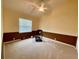 Bedroom featuring a ceiling fan, neutral carpet and two-tone brown and cream walls at 4808 Jewell Ter, Palm Harbor, FL 34685