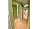 Hallway with mirrored walls leading to the main bathroom at 4808 Jewell Ter, Palm Harbor, FL 34685