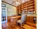Inviting home office with custom built-ins, hardwood floors, and a light-filled ambiance at 4808 Jewell Ter, Palm Harbor, FL 34685