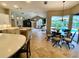 Open-concept kitchen that looks out to the pool and features a breakfast bar and dining area at 4808 Jewell Ter, Palm Harbor, FL 34685