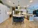 Bright kitchen featuring a large center island, stainless steel appliances, and stylish pendant lighting at 4808 Jewell Ter, Palm Harbor, FL 34685
