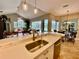 Kitchen featuring stainless steel appliances, stone countertops, and seamless flow to living and dining areas at 4808 Jewell Ter, Palm Harbor, FL 34685