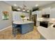 Modern kitchen with white cabinetry, updated appliances, breakfast bar, and ample counter space at 4808 Jewell Ter, Palm Harbor, FL 34685