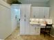 Kitchen view showcasing the built-in desk and walk-in pantry adjacent to the refrigerator and modern cabinets at 4808 Jewell Ter, Palm Harbor, FL 34685