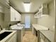 Well-organized laundry room with white cabinetry, modern appliances, and ample counter space at 4808 Jewell Ter, Palm Harbor, FL 34685