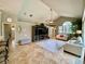 Bright living room with high ceilings, tile floors, and a large entertainment center at 4808 Jewell Ter, Palm Harbor, FL 34685