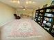 Spacious living room featuring a large rug, comfortable seating, and a built-in bookshelf at 4808 Jewell Ter, Palm Harbor, FL 34685