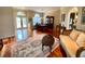 Elegant living area with beautiful wood floors, seating, dining area, and bright windows at 4808 Jewell Ter, Palm Harbor, FL 34685