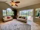 Comfortable living room with vaulted ceilings and a view of the private pool at 4808 Jewell Ter, Palm Harbor, FL 34685