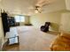 Spacious living room with a ceiling fan, a large rug, and comfortable seating at 4808 Jewell Ter, Palm Harbor, FL 34685